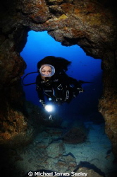 The undrwater model Belen Caro entering a cave in Tenerife by Michael James Sealey 